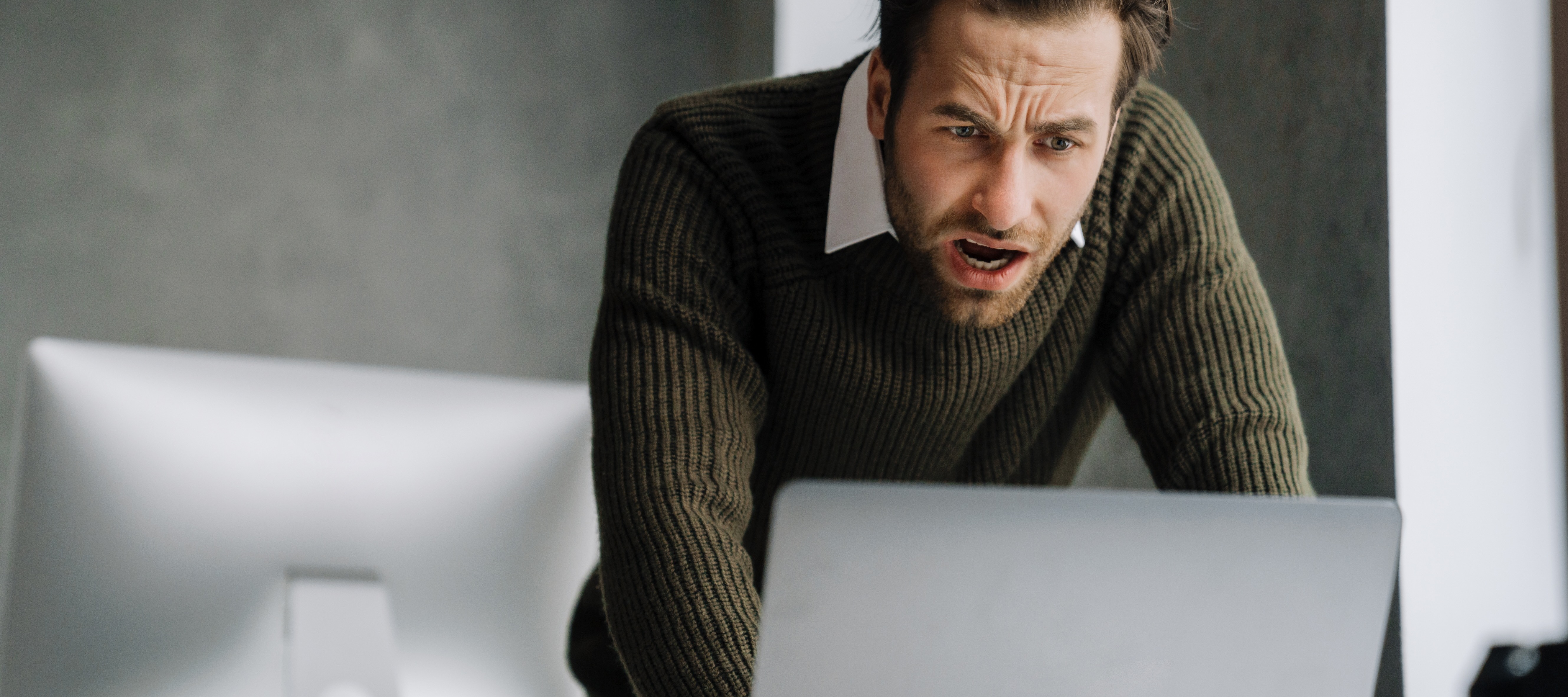man upset looking at computer