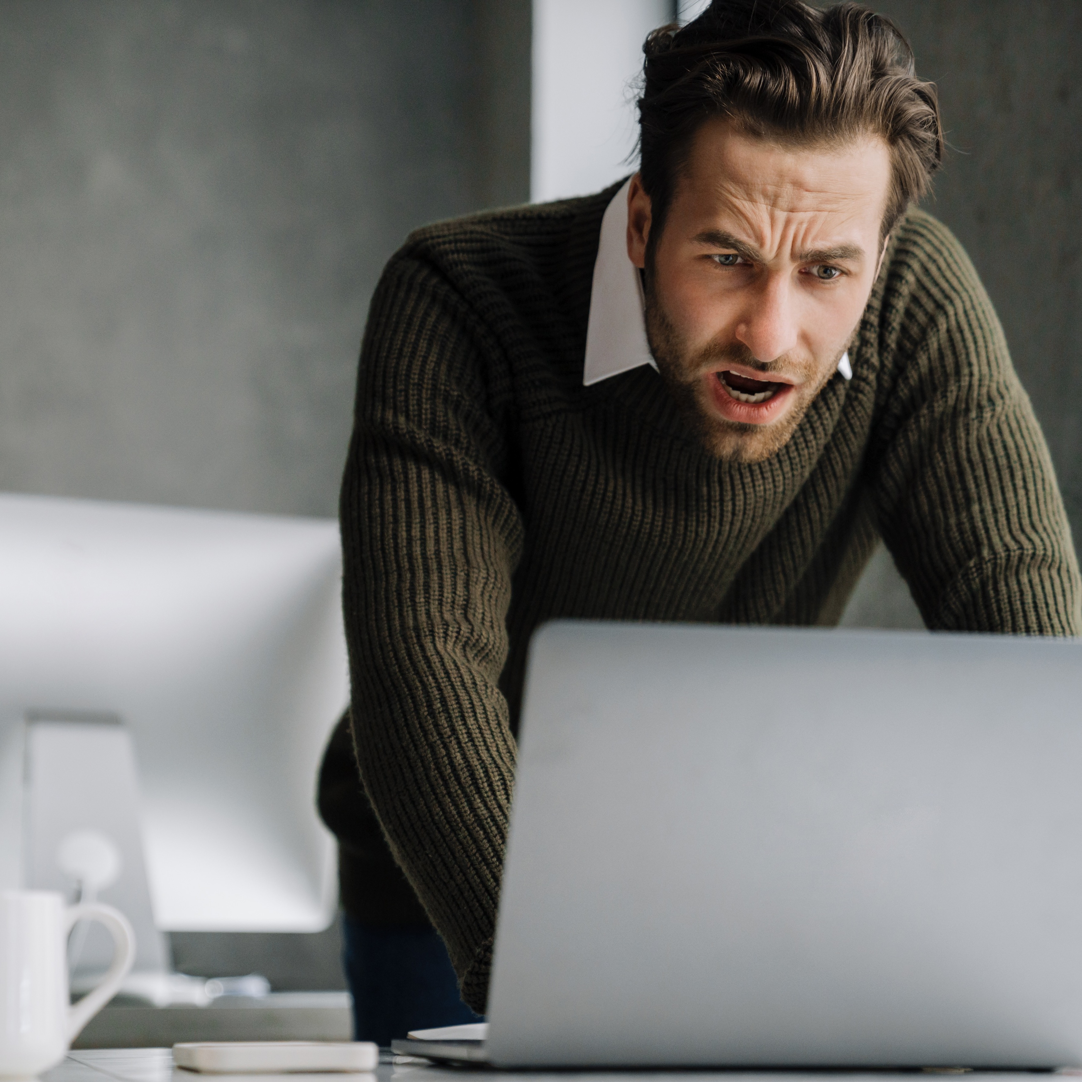 man upset looking at computer