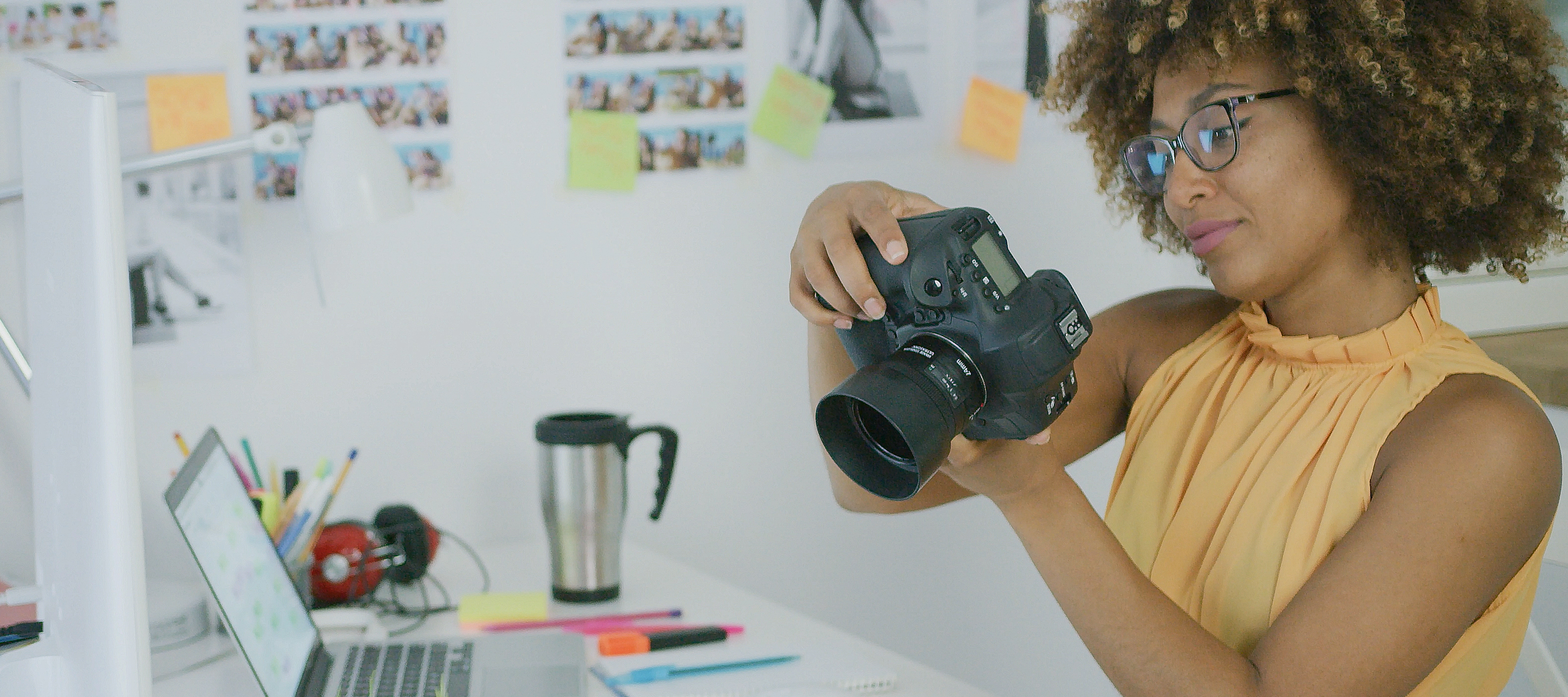 Photographer sitting at her desk looking at photos