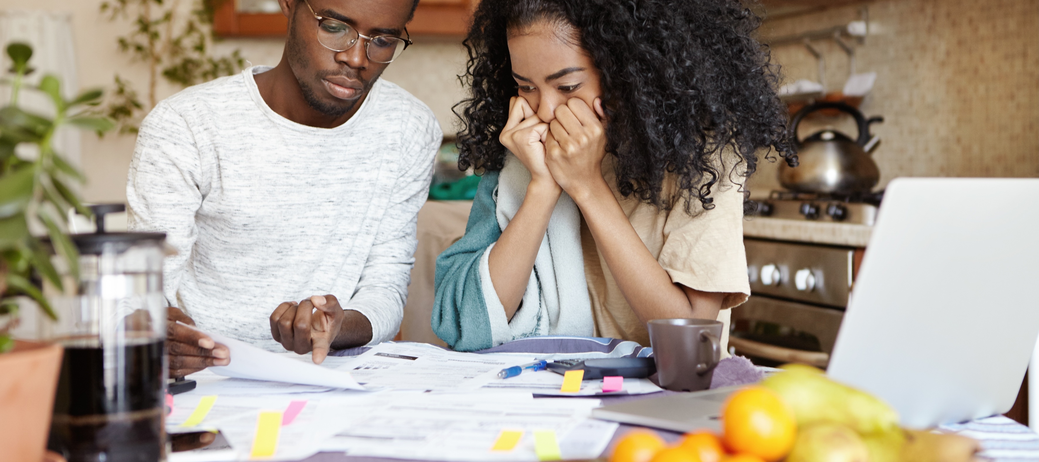 A couple looking at finances and the man points to something on paper