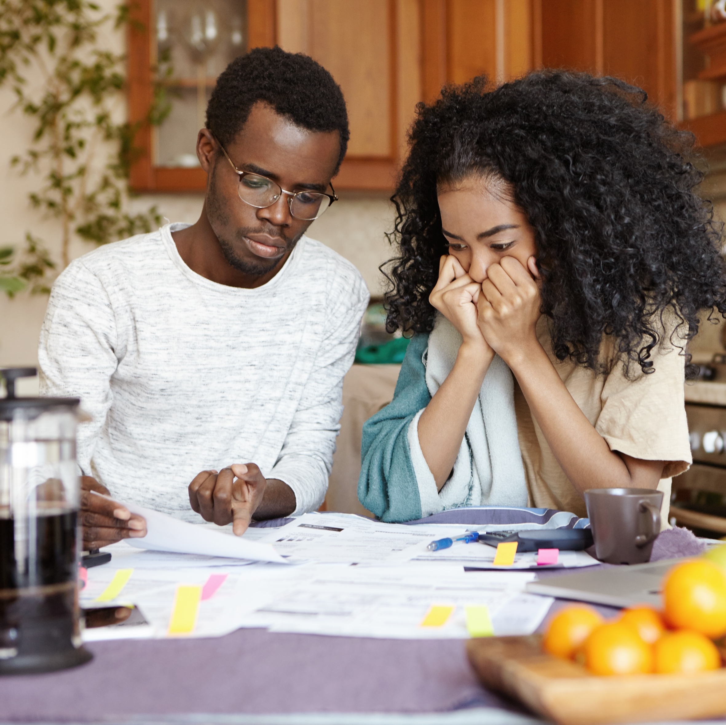 A couple looking at finances and the man points to something on paper