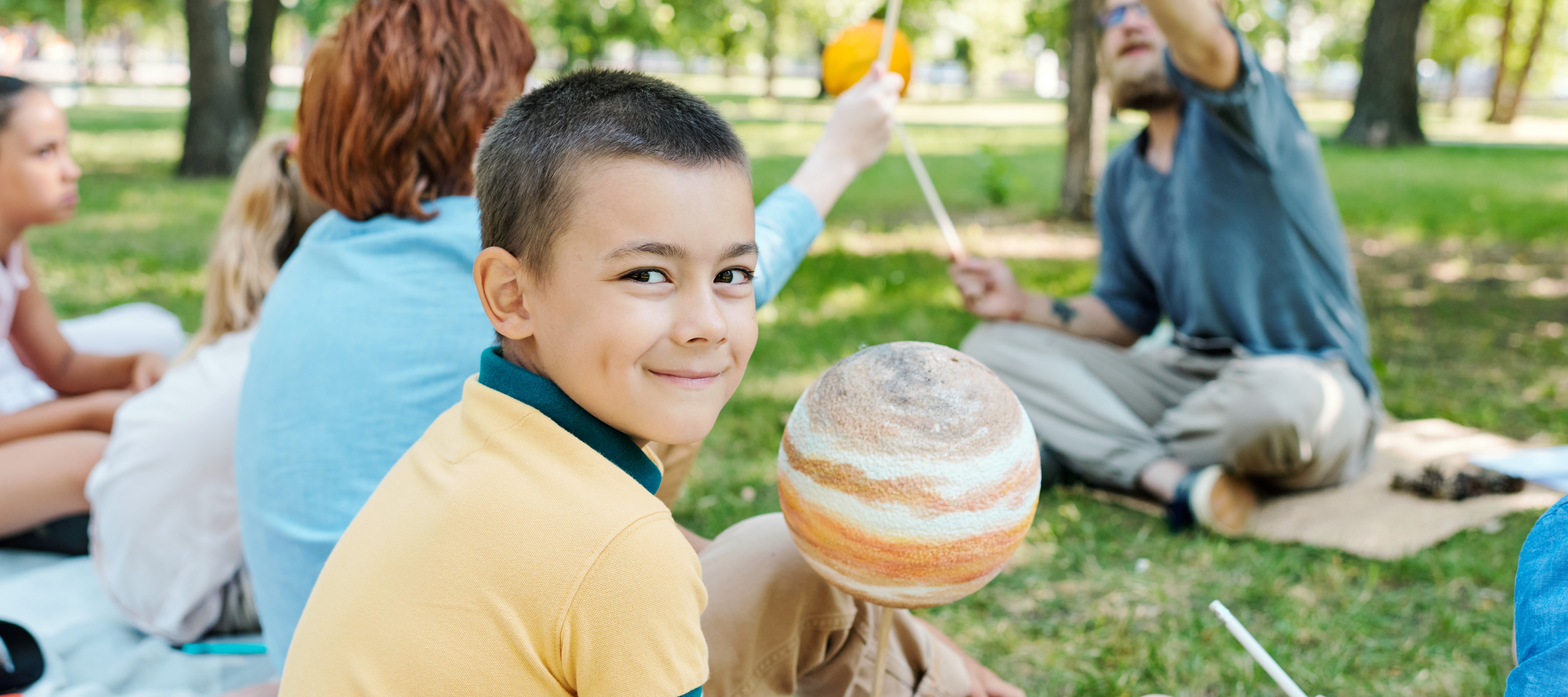Young child learning about solar system at summer camp