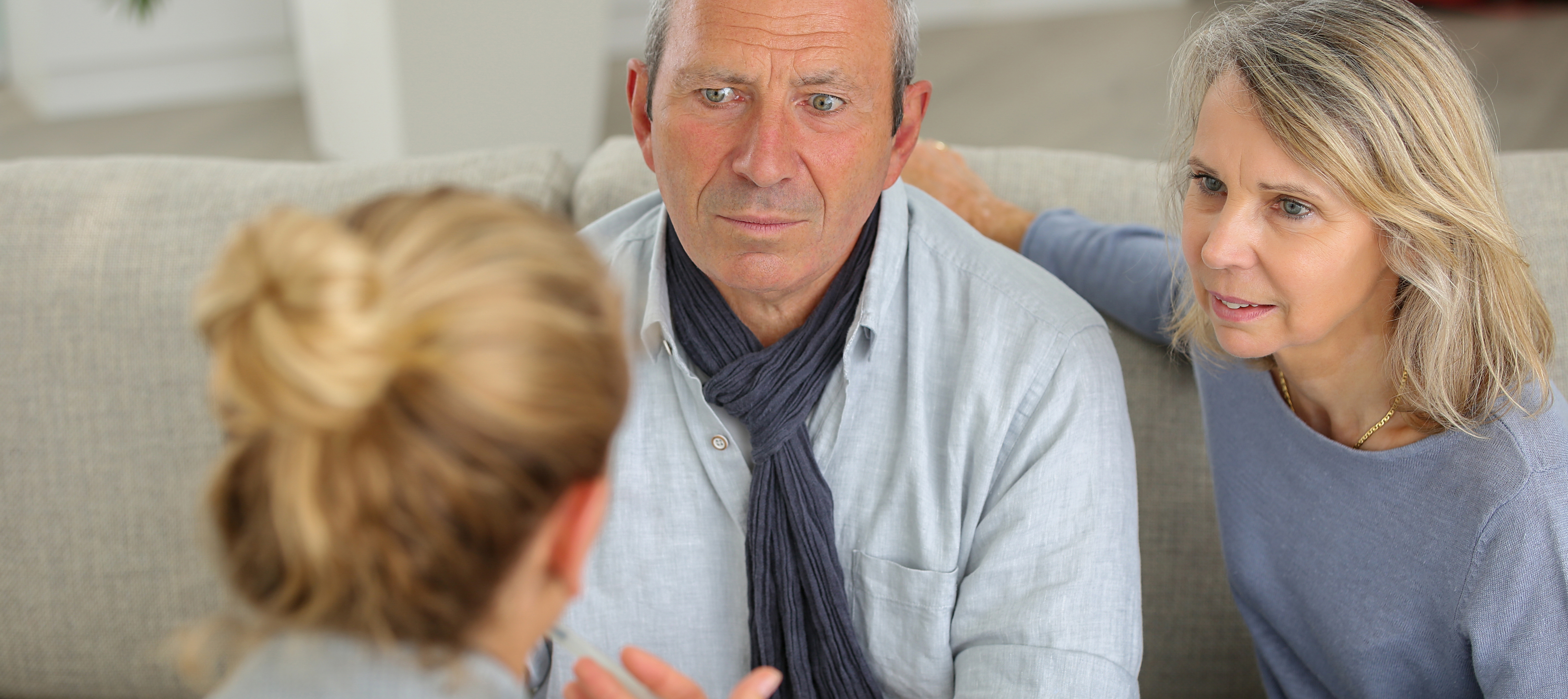 A young woman discussing an issue with her parents.