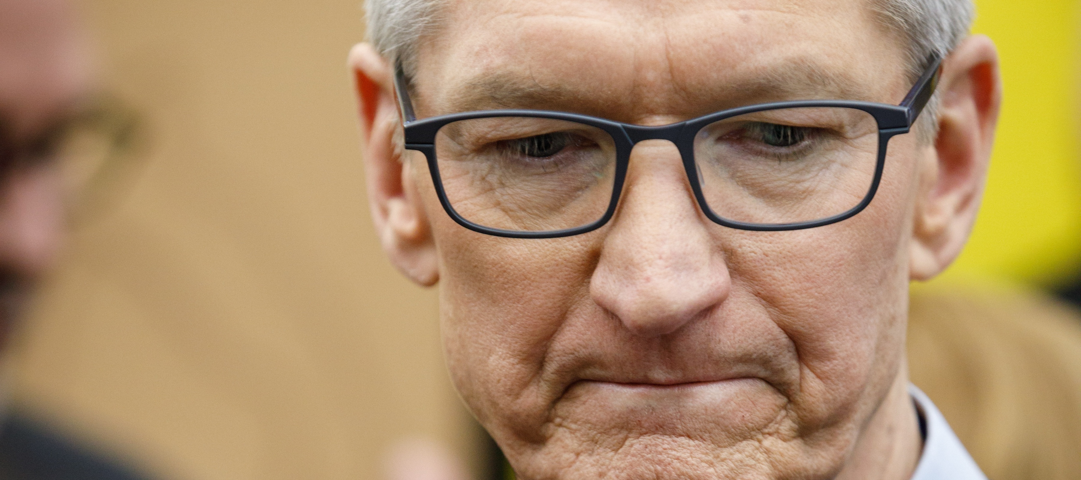 Apple CEO Tim Cook looking down and sad