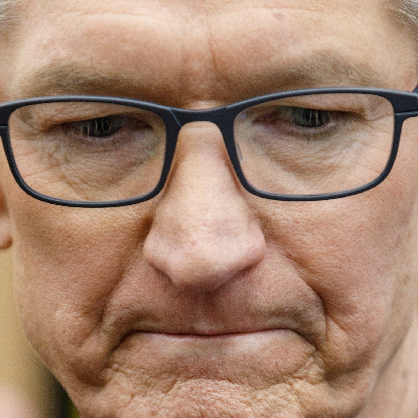 Apple CEO Tim Cook looking down and sad