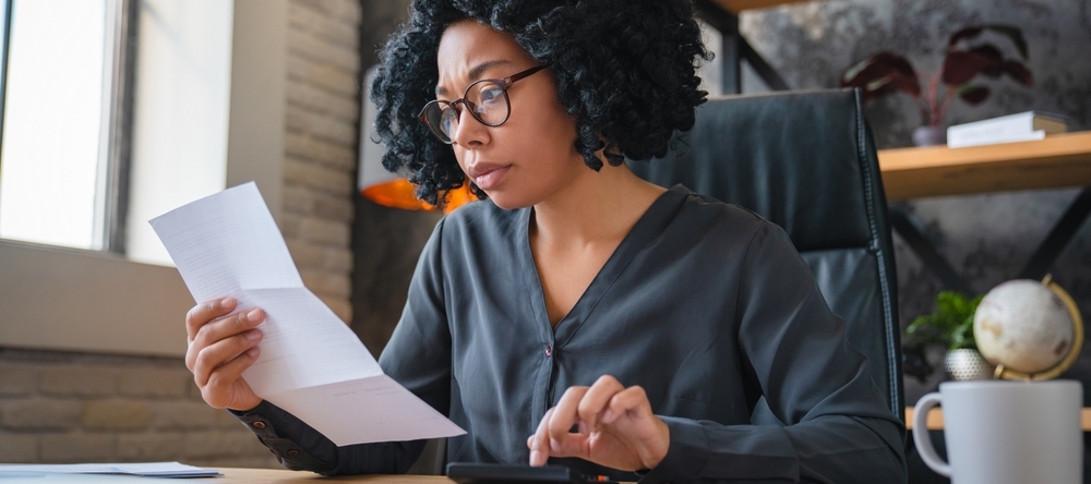 A photo of a woman reviewing her finances