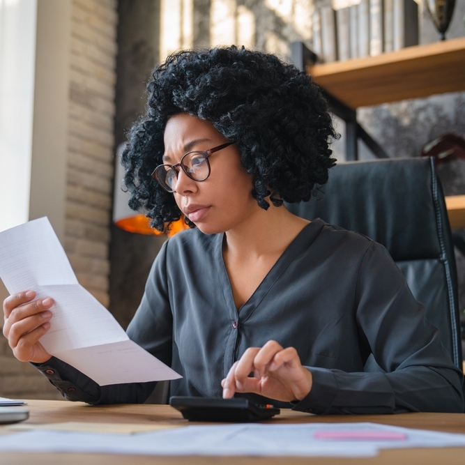 A photo of a woman reviewing her finances