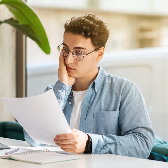 Confused man looking at documents.