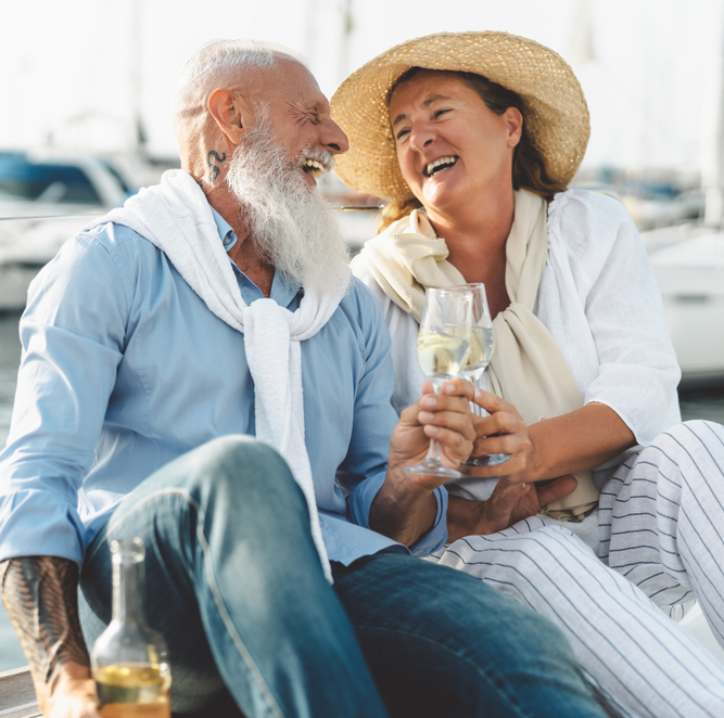 Wealthy couple laughing on a yacht.