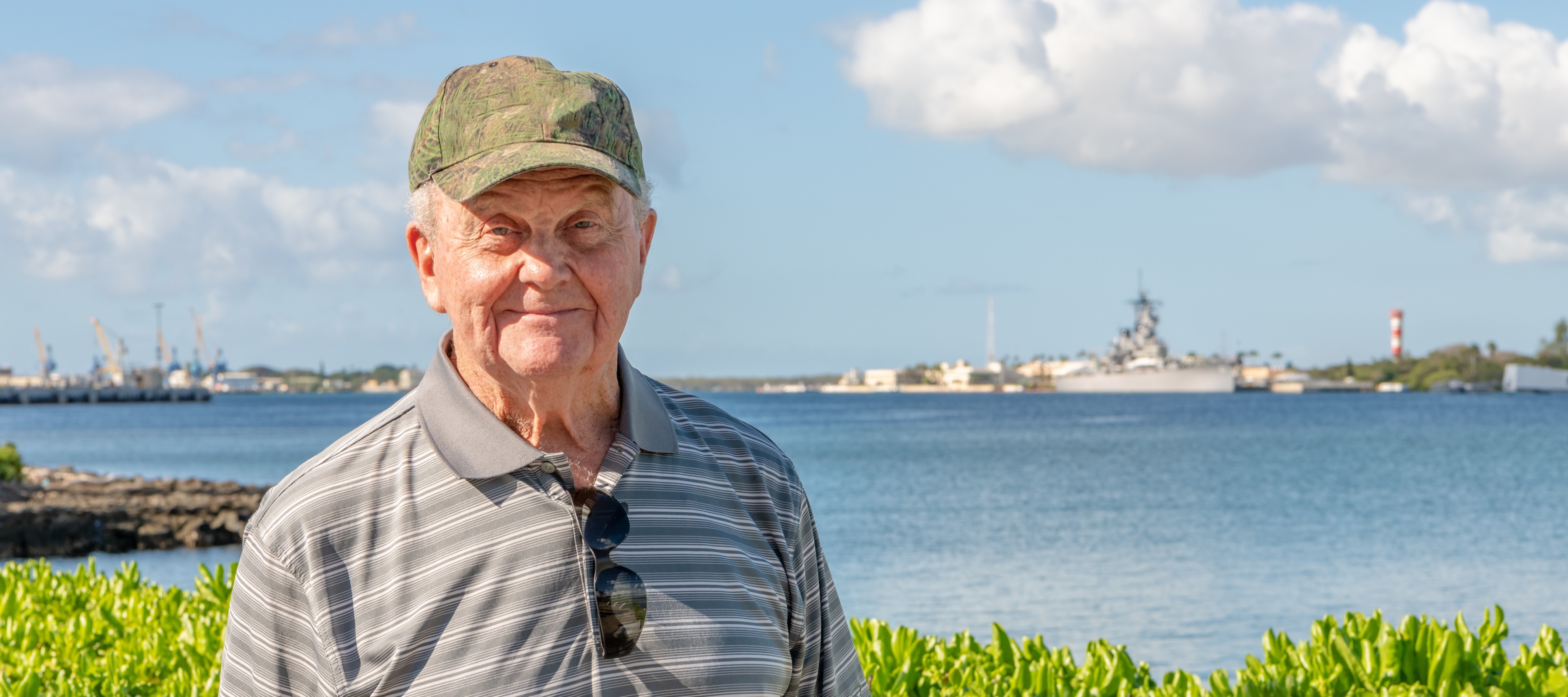 A senior man, a veteran, visiting historical sites during a family trip to Hawaii.