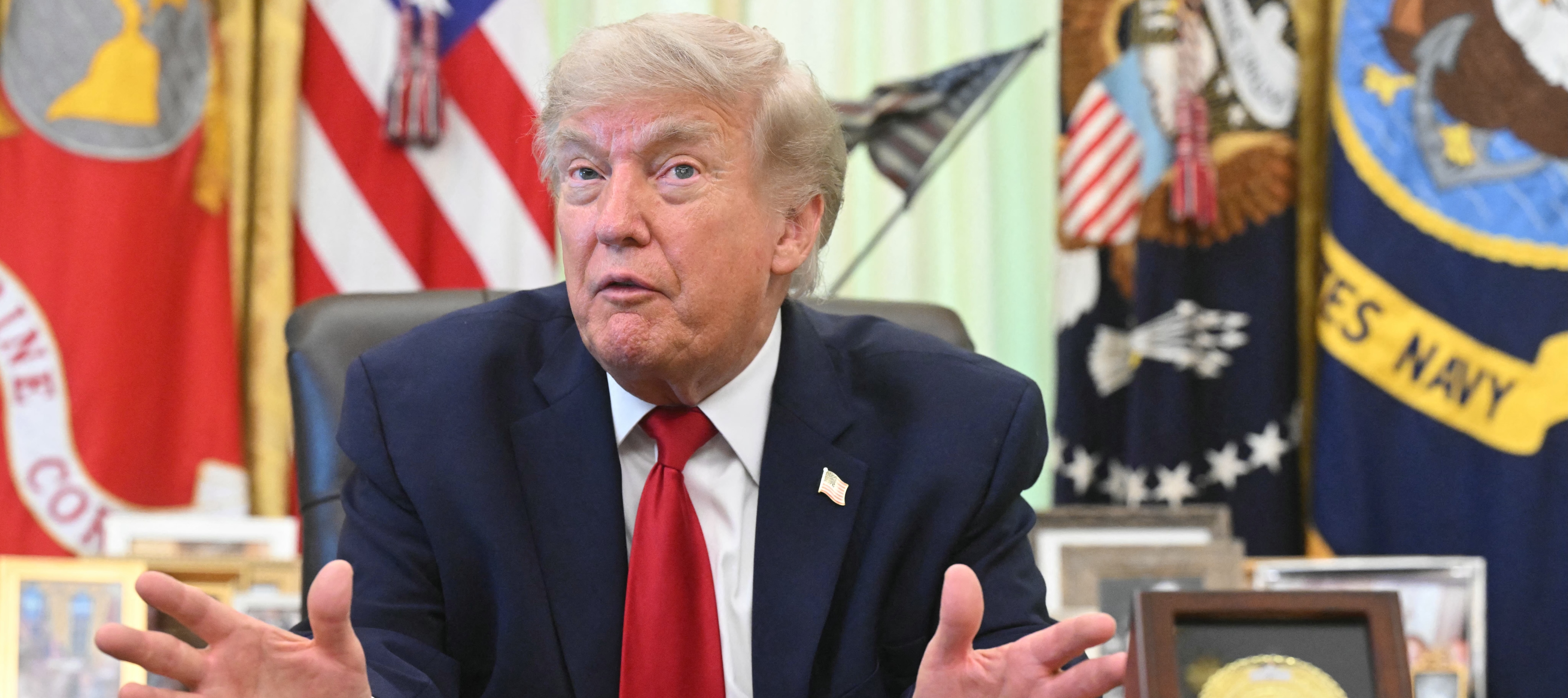 US President Donald Trump speaks with reporters after signing a presidential memo on pollution control in vehicles at the Oval Office.