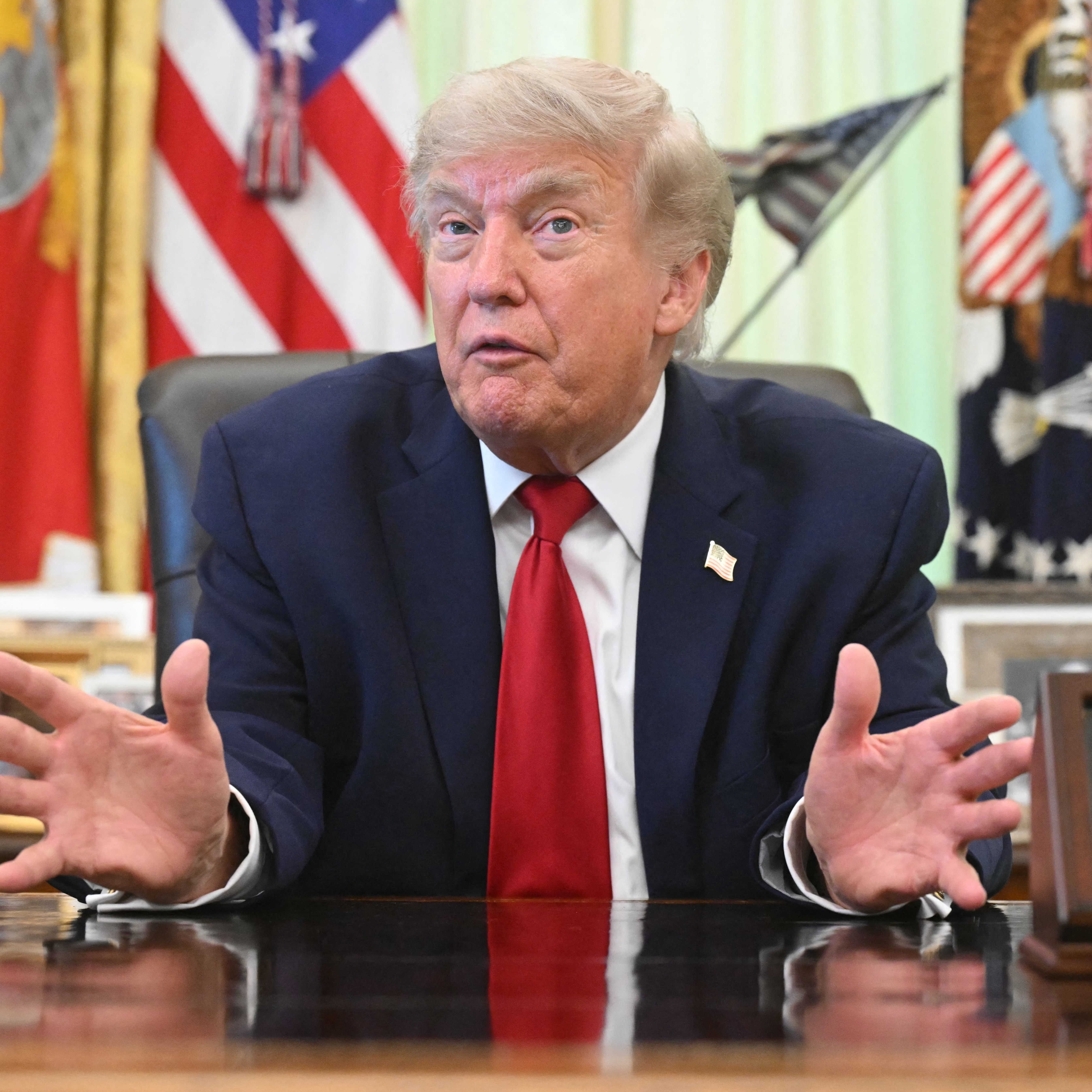 US President Donald Trump speaks with reporters after signing a presidential memo on pollution control in vehicles at the Oval Office.