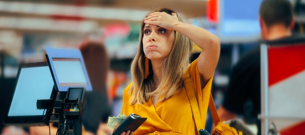 Woman annoyed while checking out at the grocery store.