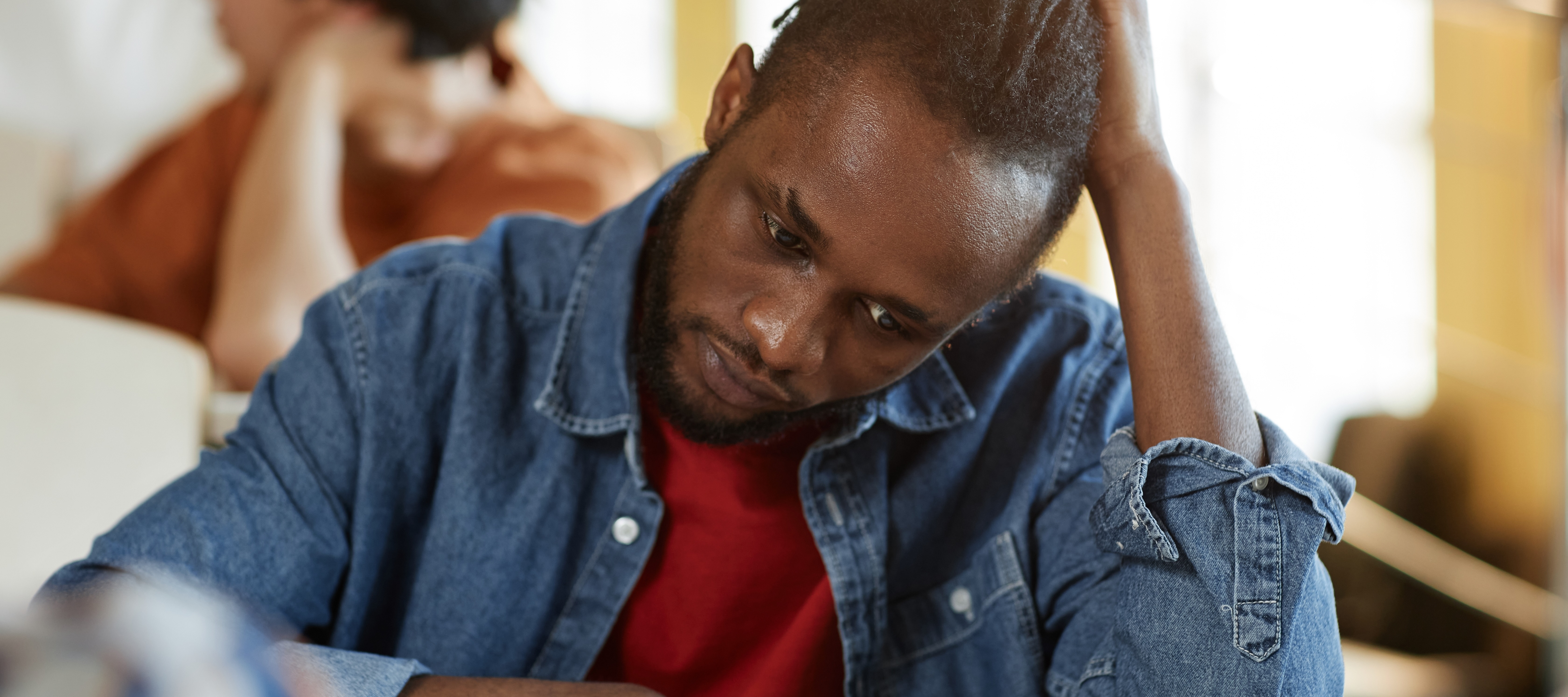 Stressed young man filling out form