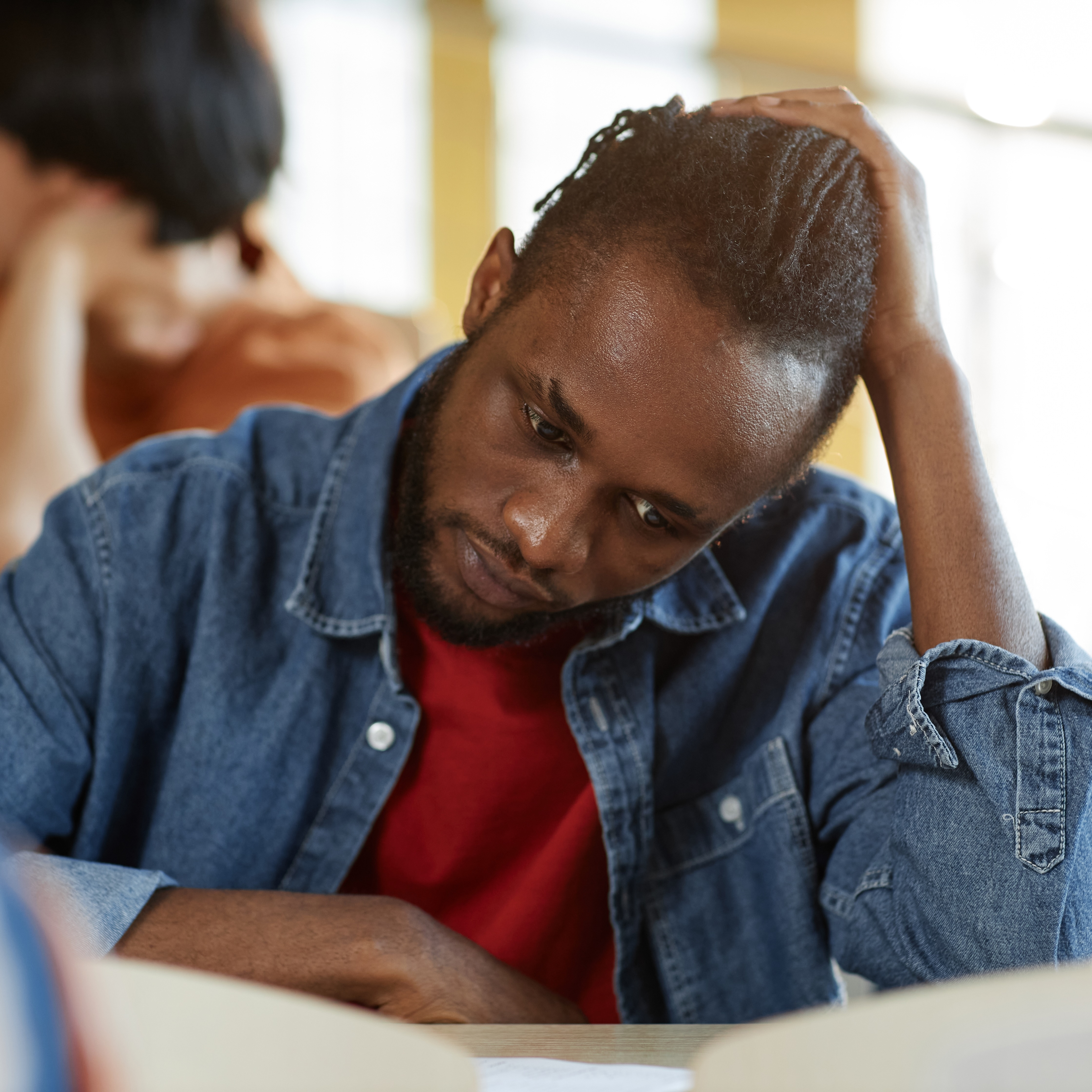 Stressed young man filling out form