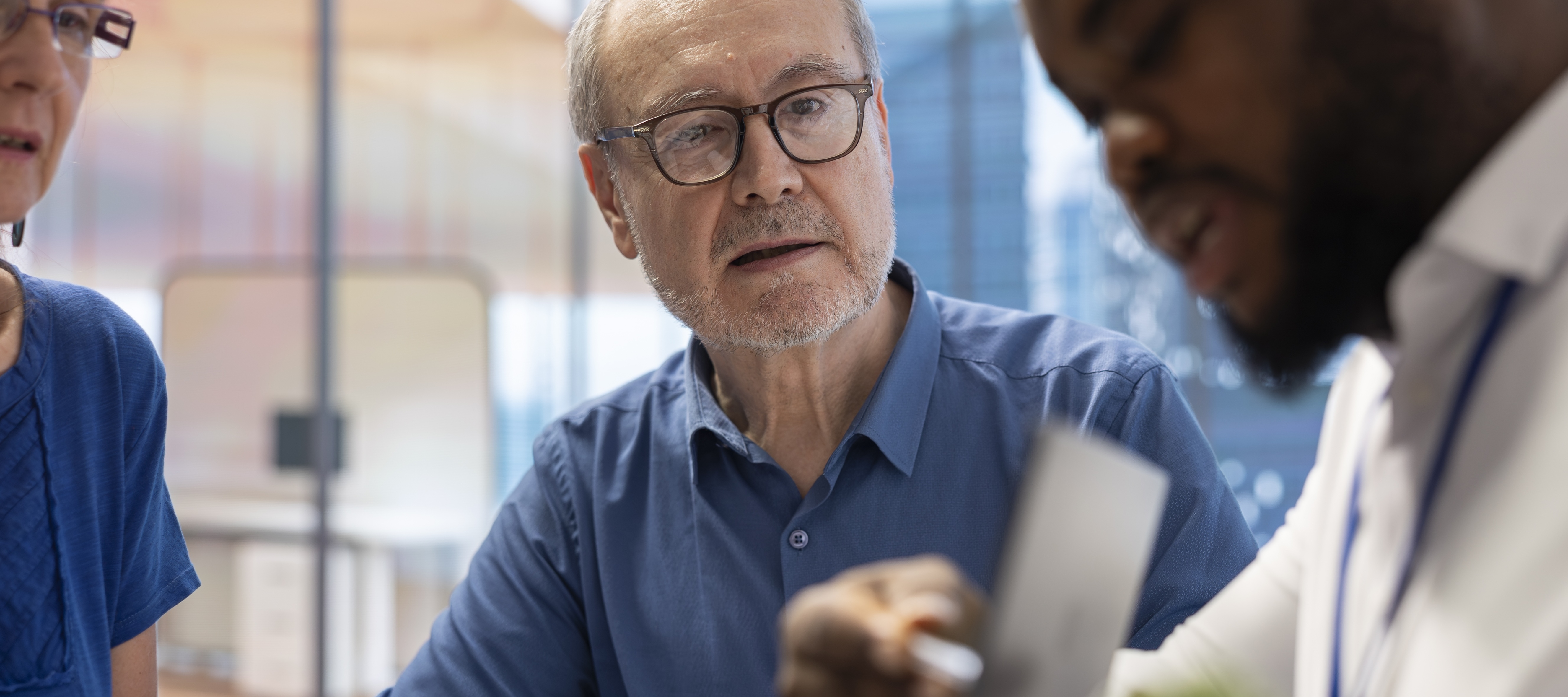 Perplexed older man speaking with younger man