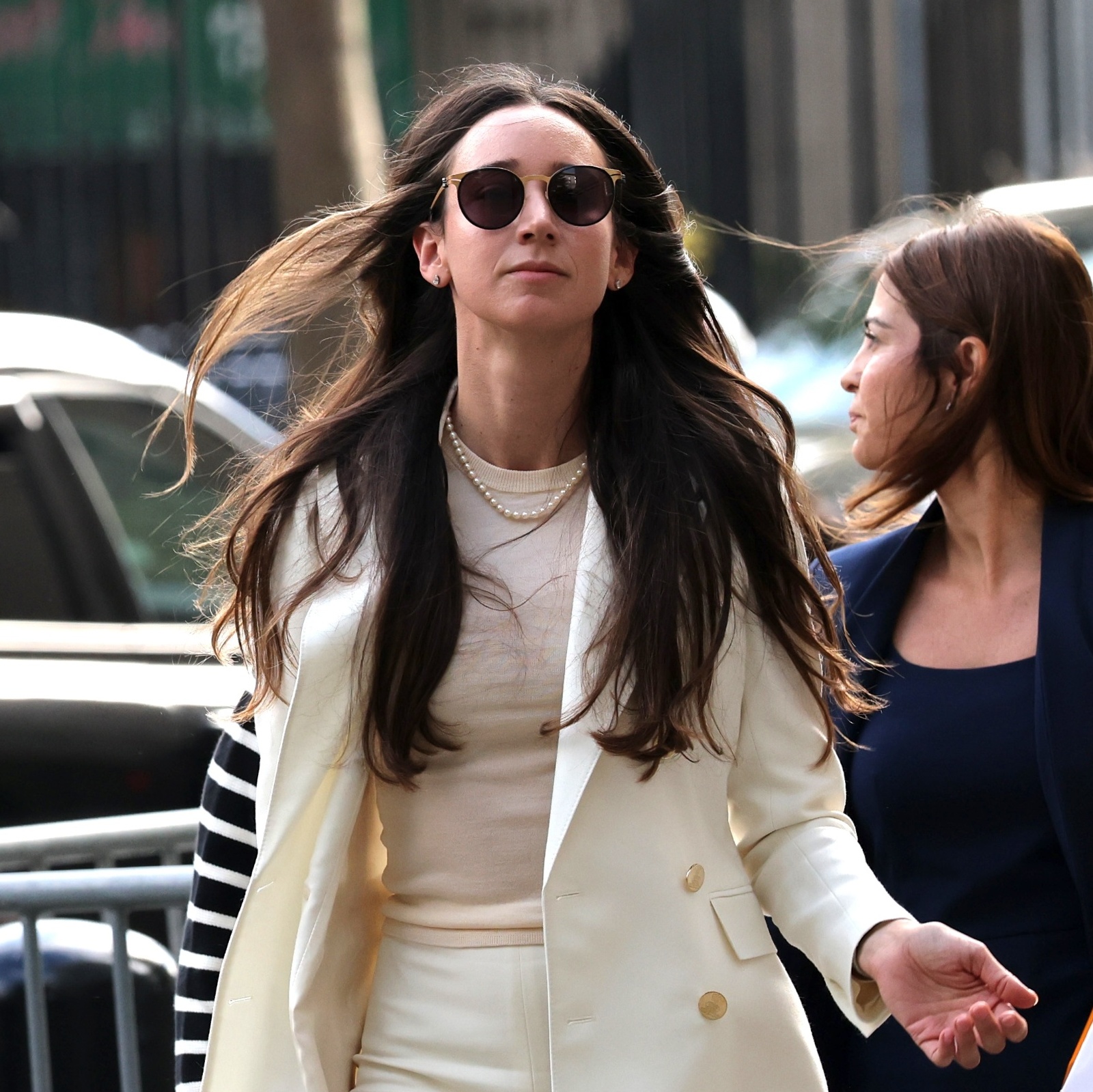 Charlie Javice arrives at court with a woman next to her holding a shopping bag