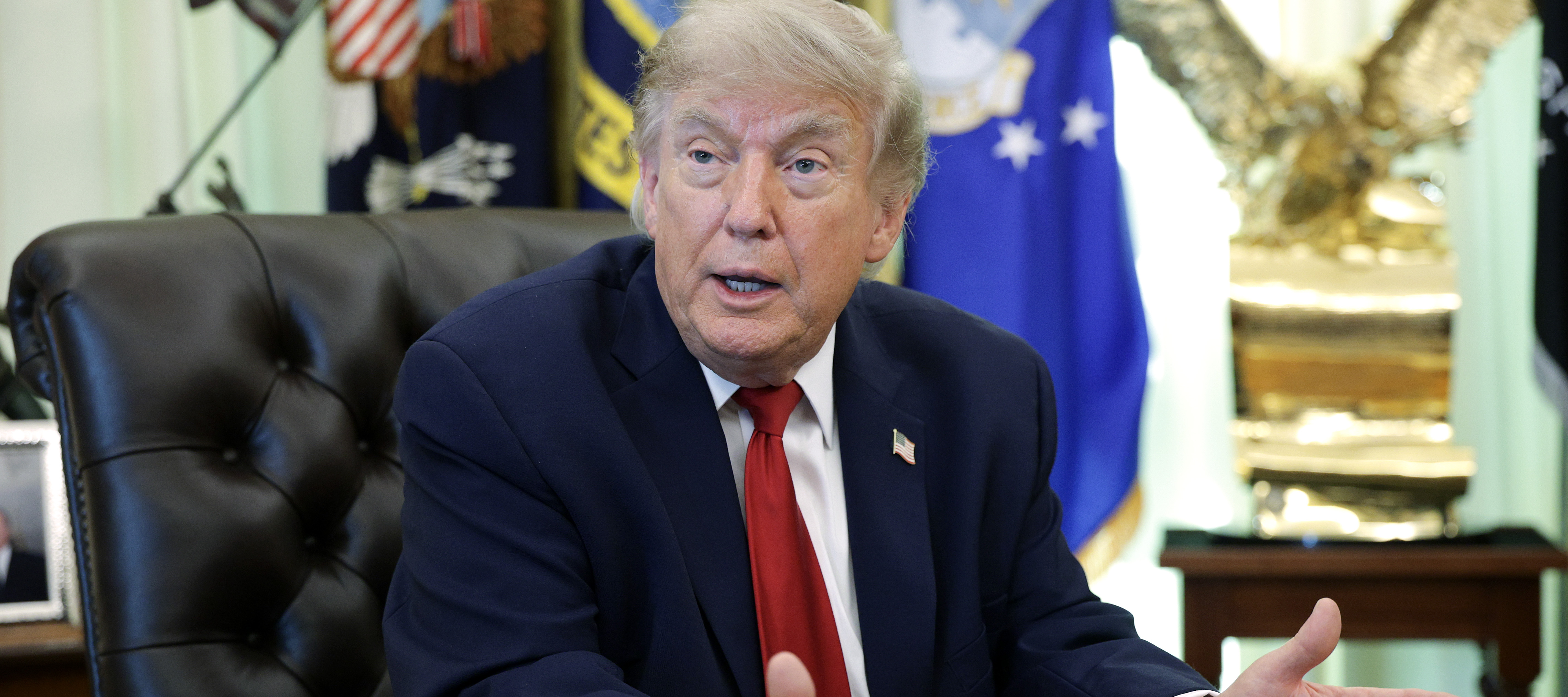 U.S. President Donald Trump talks to reporters after signing an executive order dealing with automobile repair
