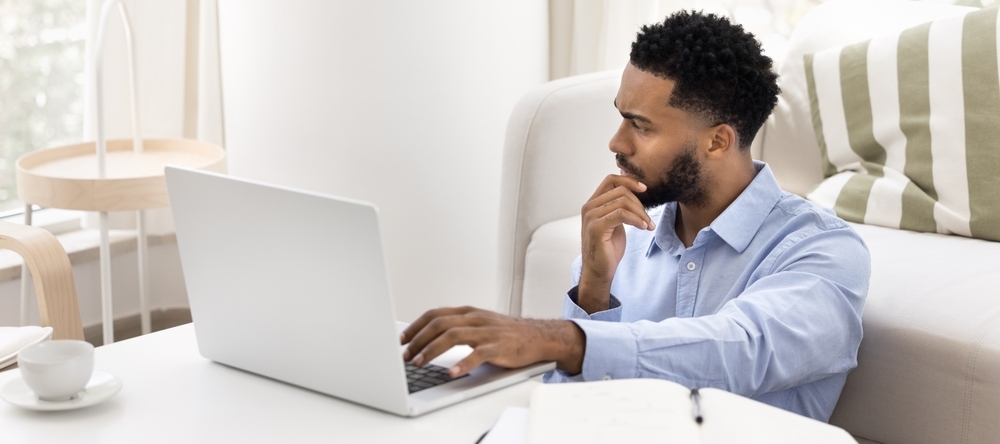 A photo of a millennial man reviewing finances
