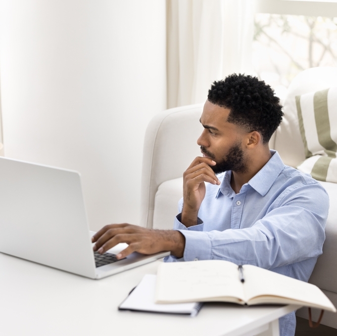 A photo of a millennial man reviewing finances