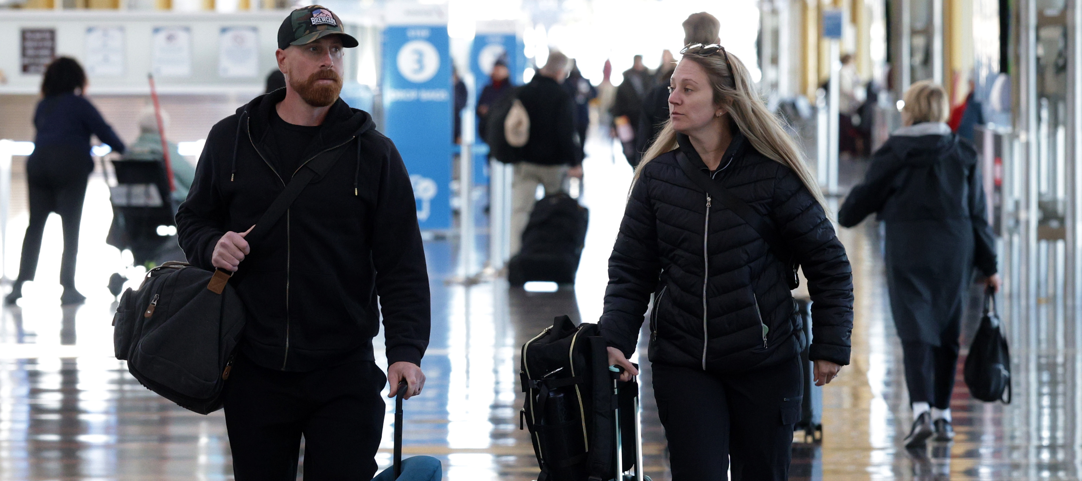 Travelers walk through Ronald Reagan Washington National Airport.