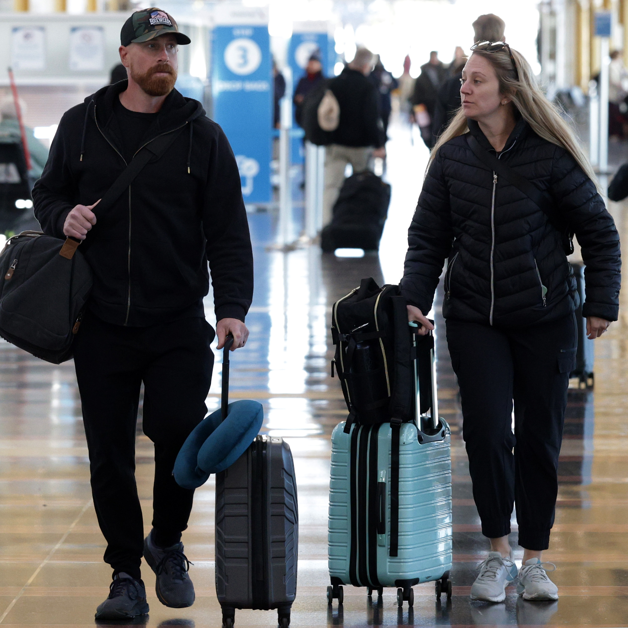 Travelers walk through Ronald Reagan Washington National Airport.
