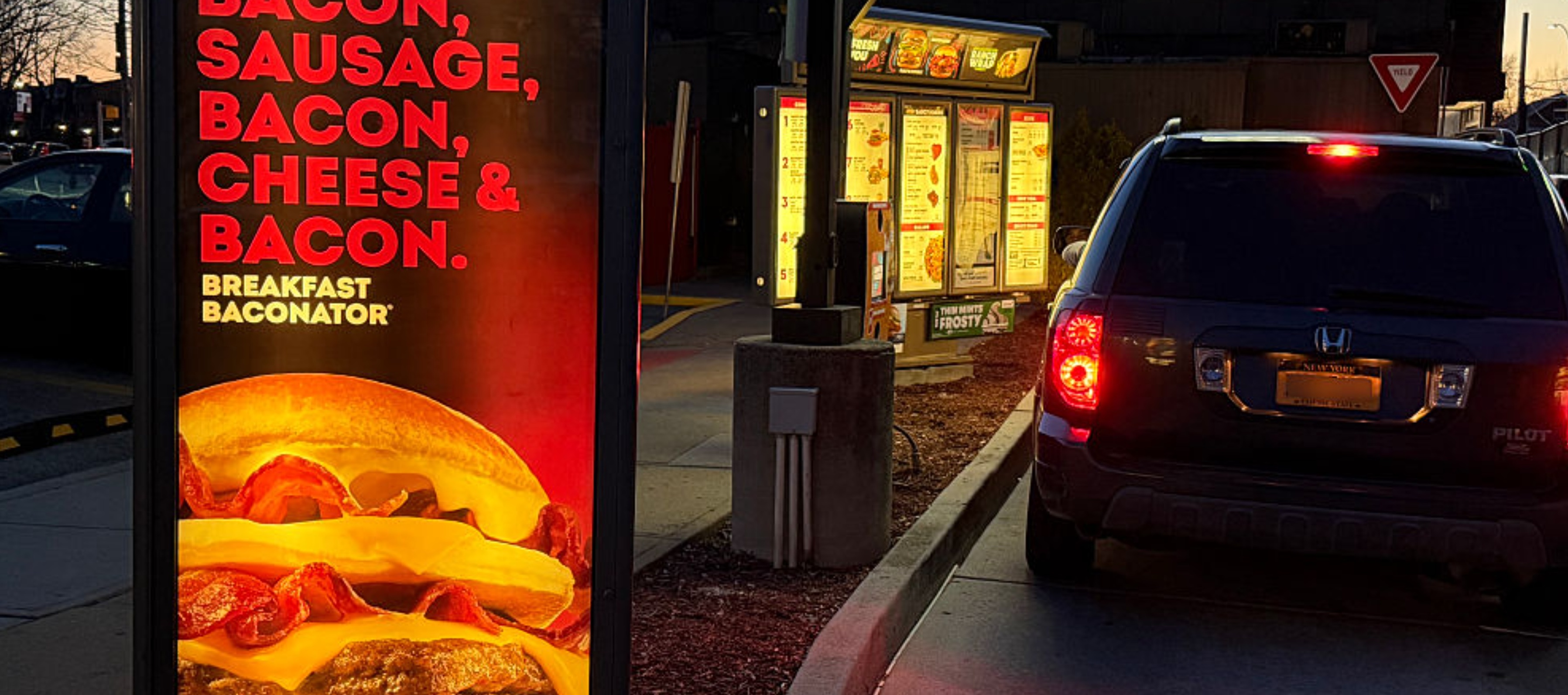 Drive Thru breakfast menu display at night, Wendys fast food restaurant.