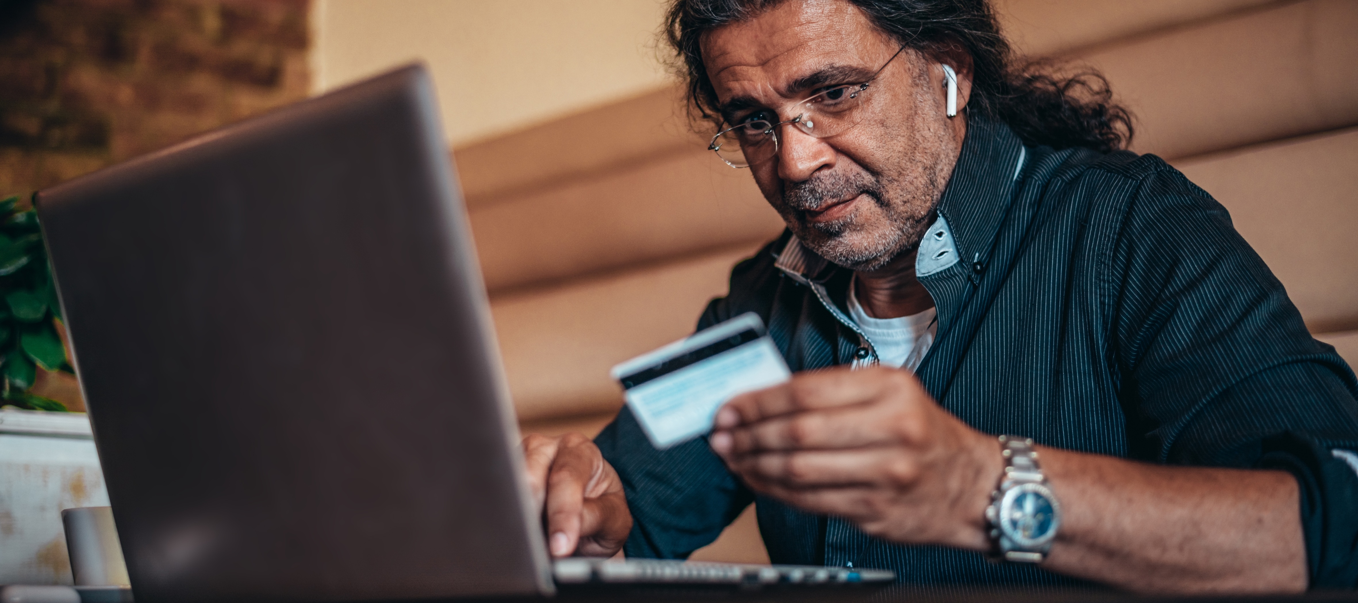 man looking at credit card