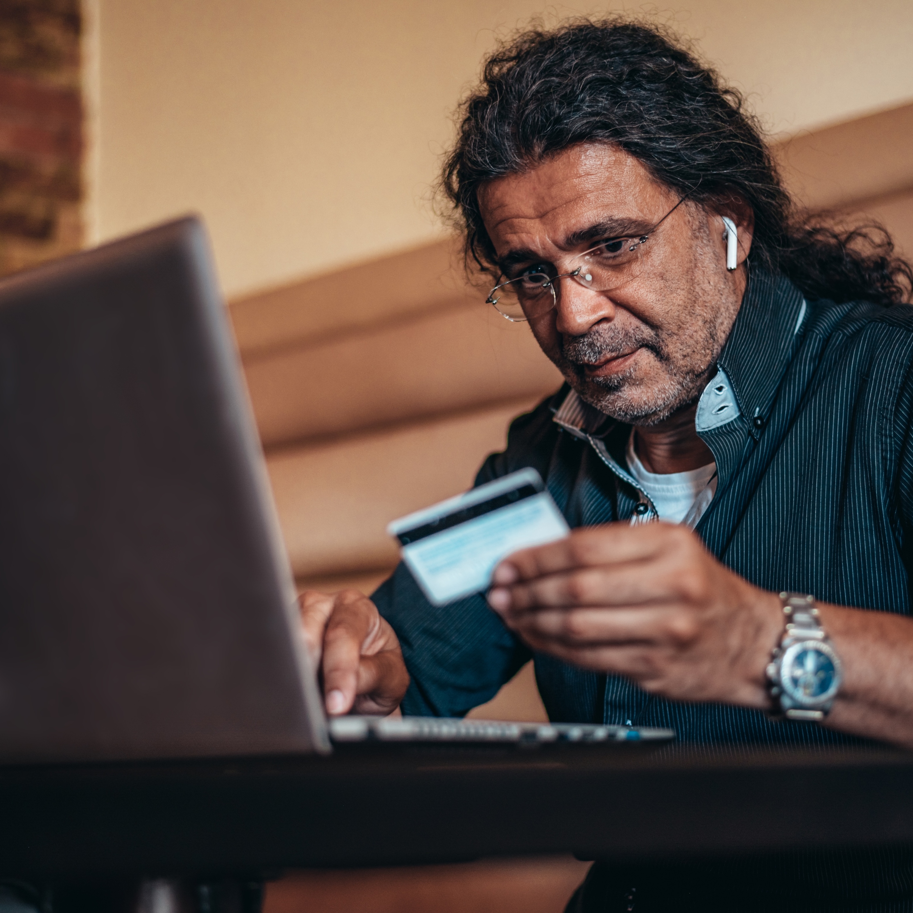man looking at credit card