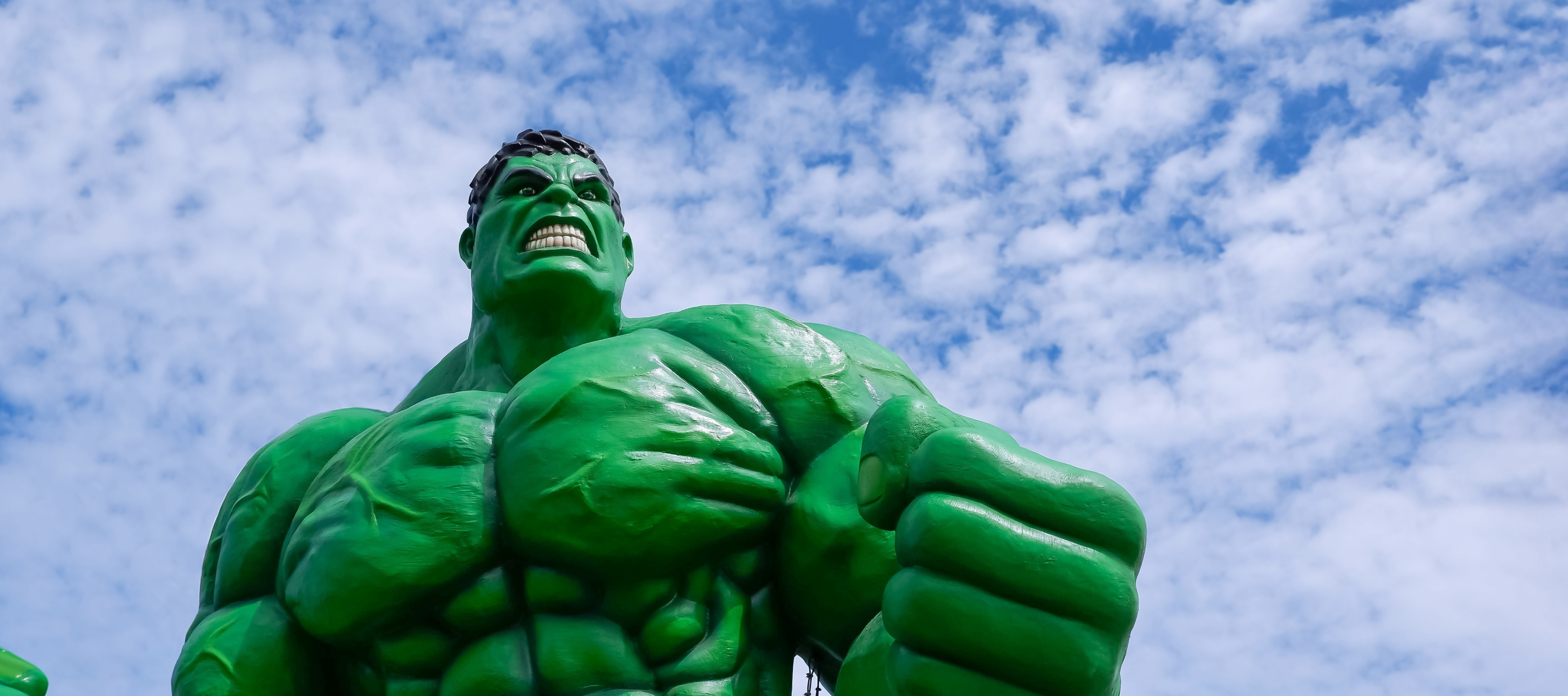 A statue of The Incredible Hulk in front of a blue sky
