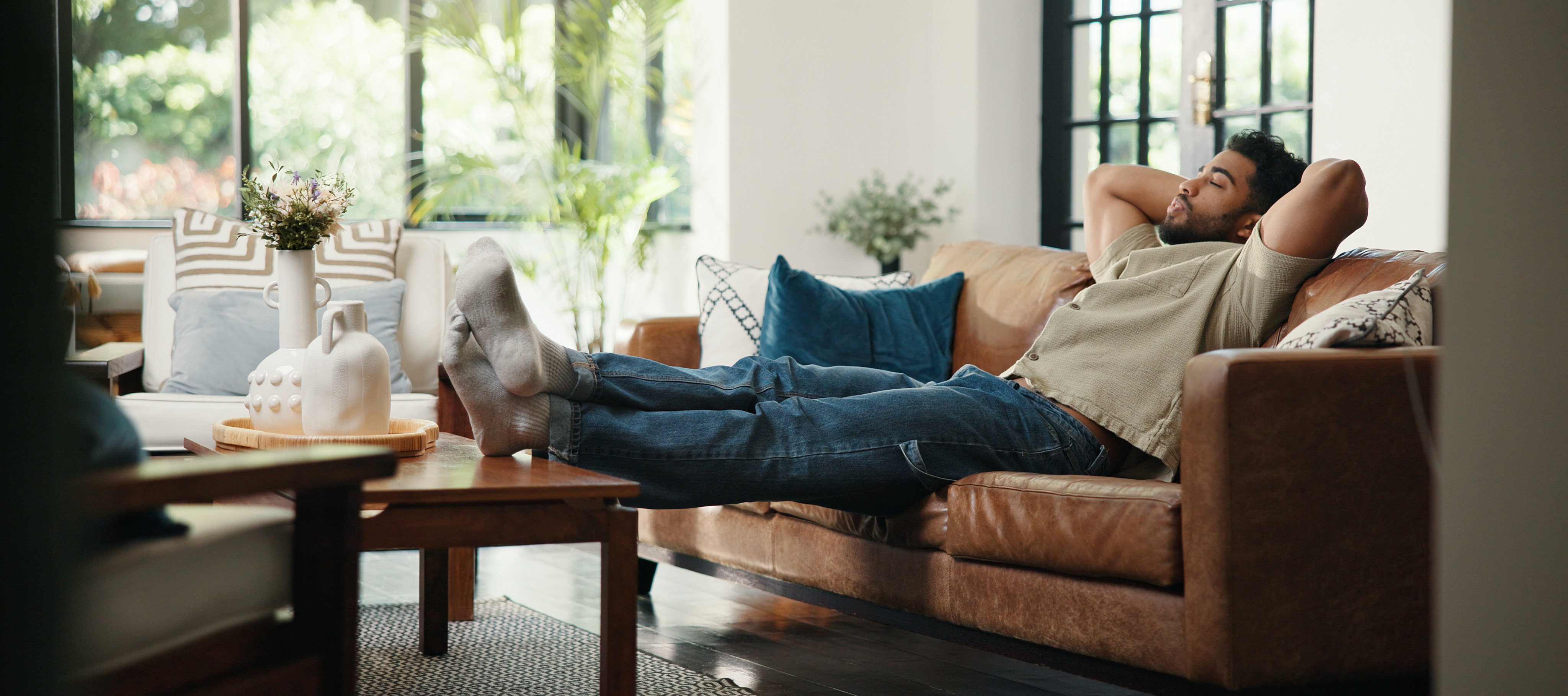 man with feet on coffee table