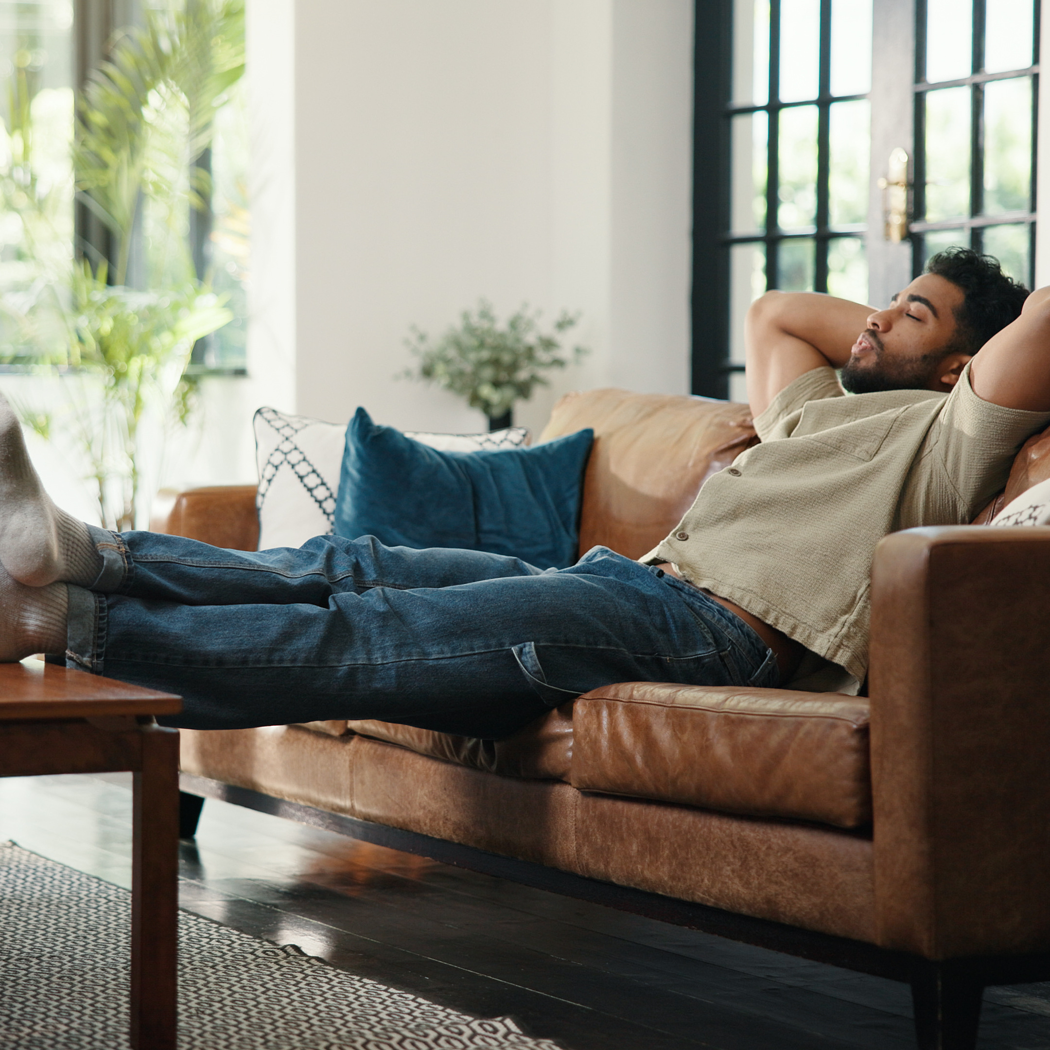 man with feet on coffee table