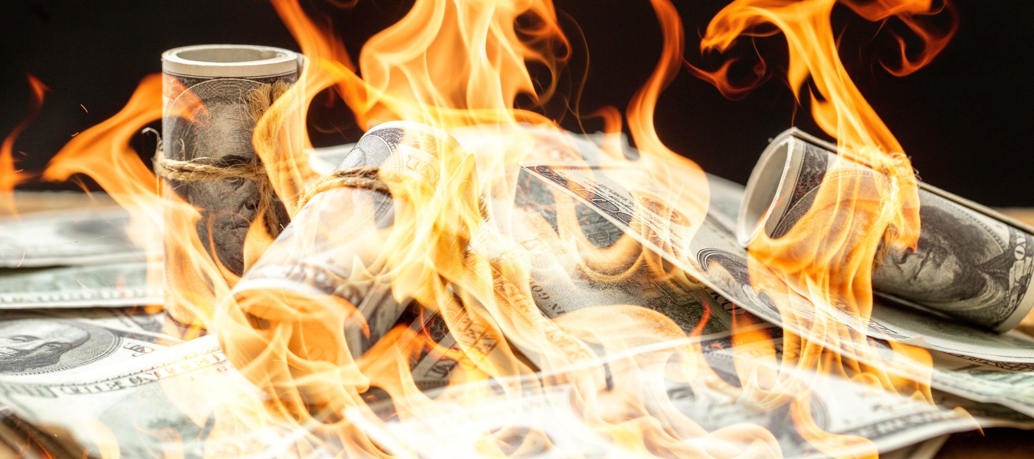 Bundles of cash on fire