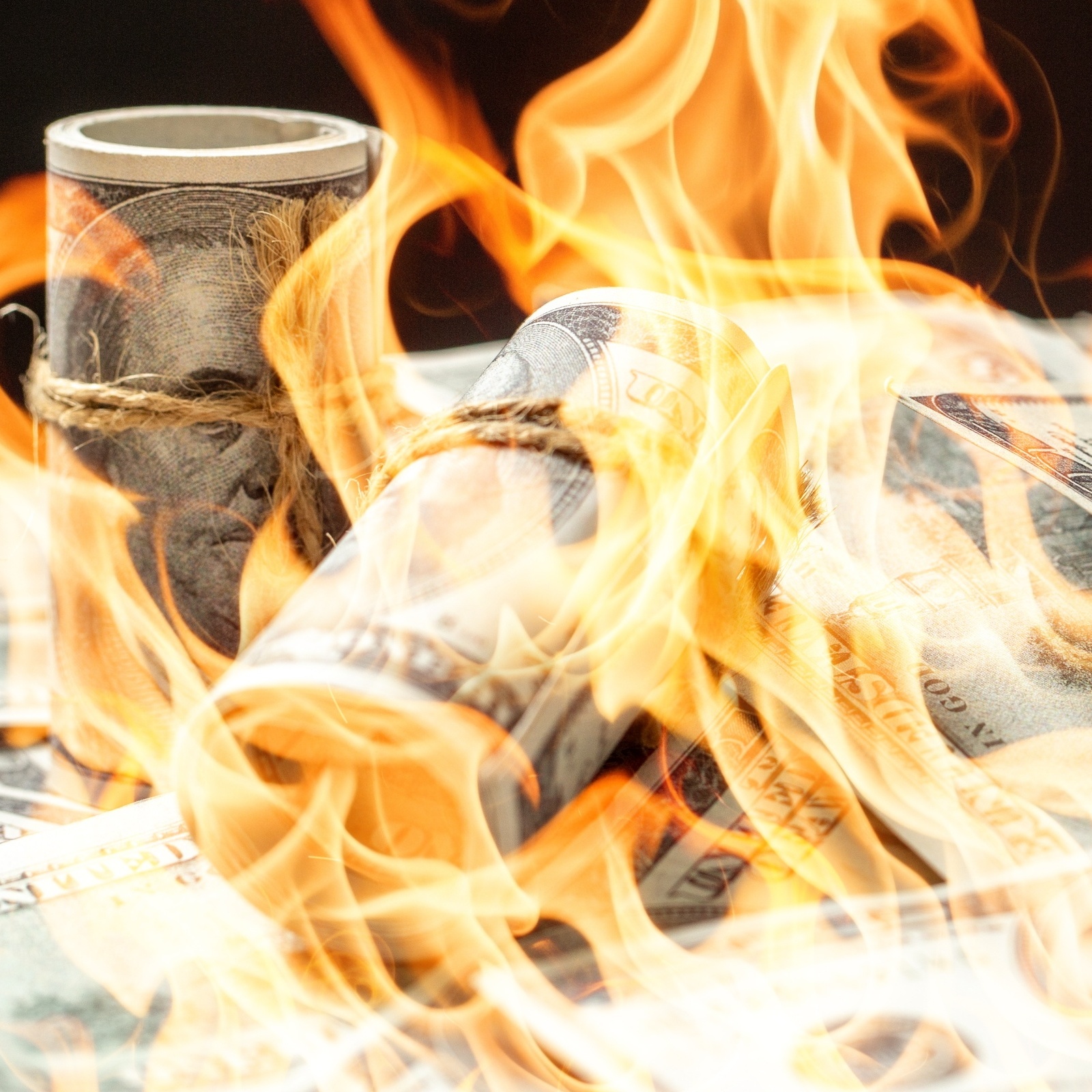 Bundles of cash on fire