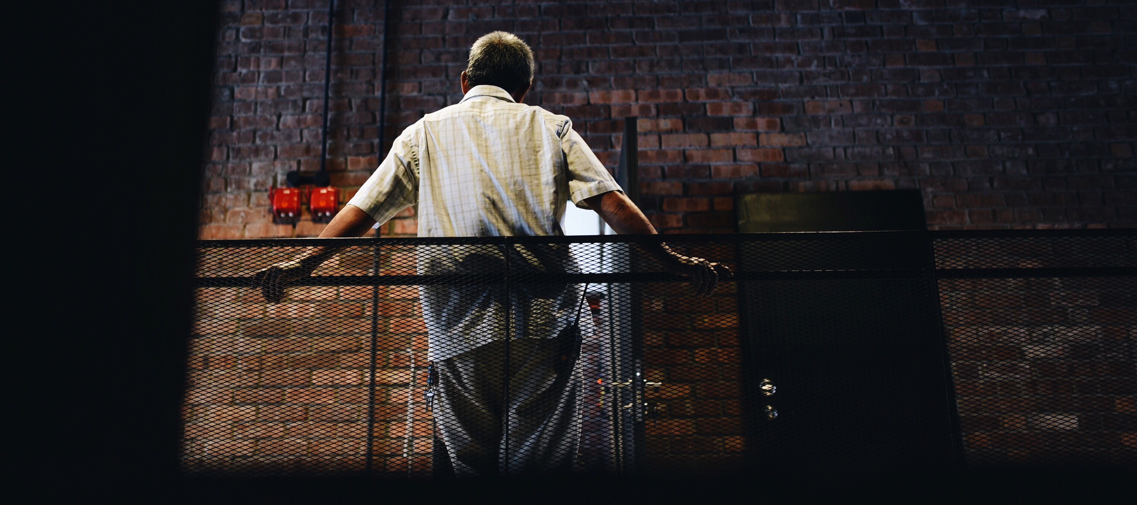 man from behind in factory