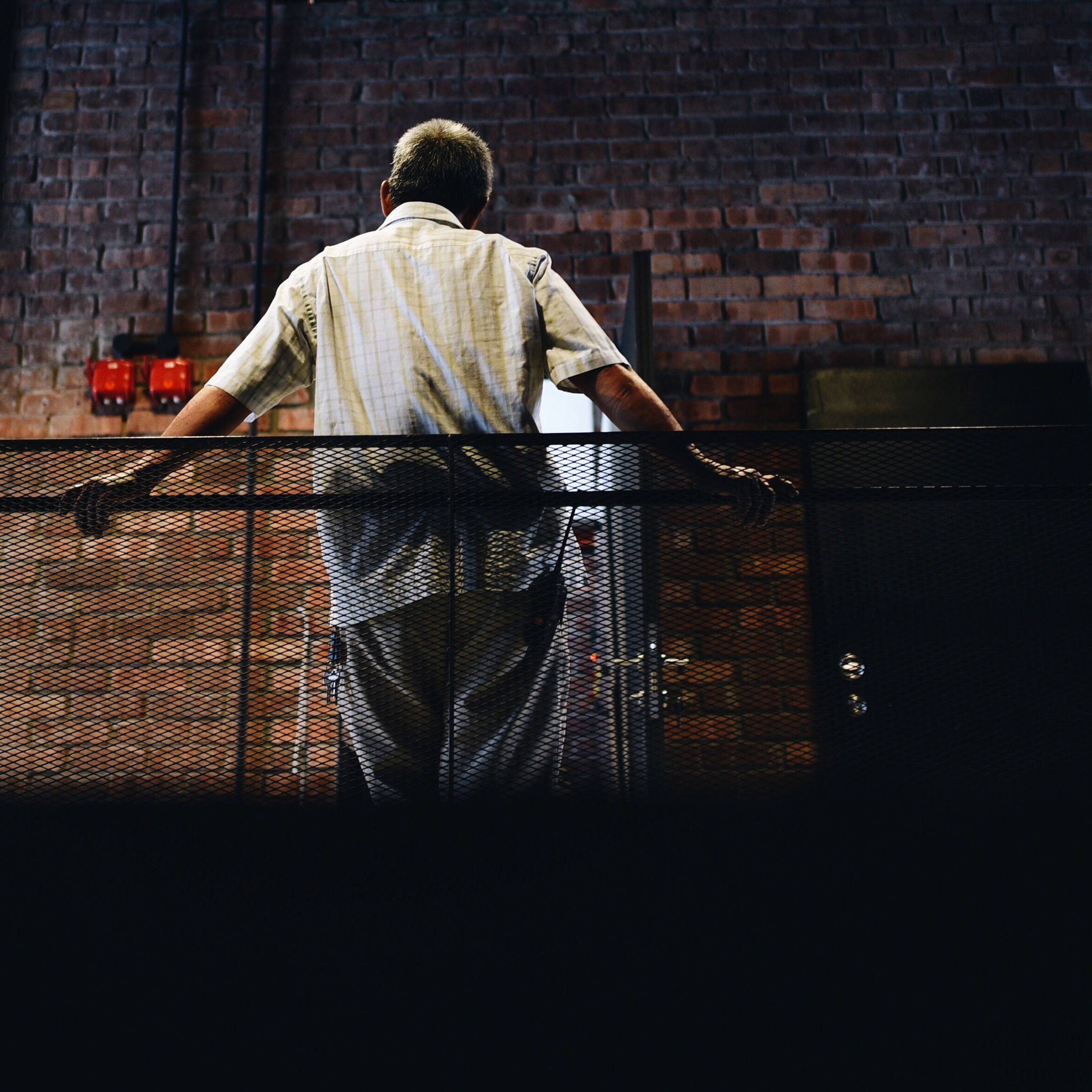 man from behind in factory