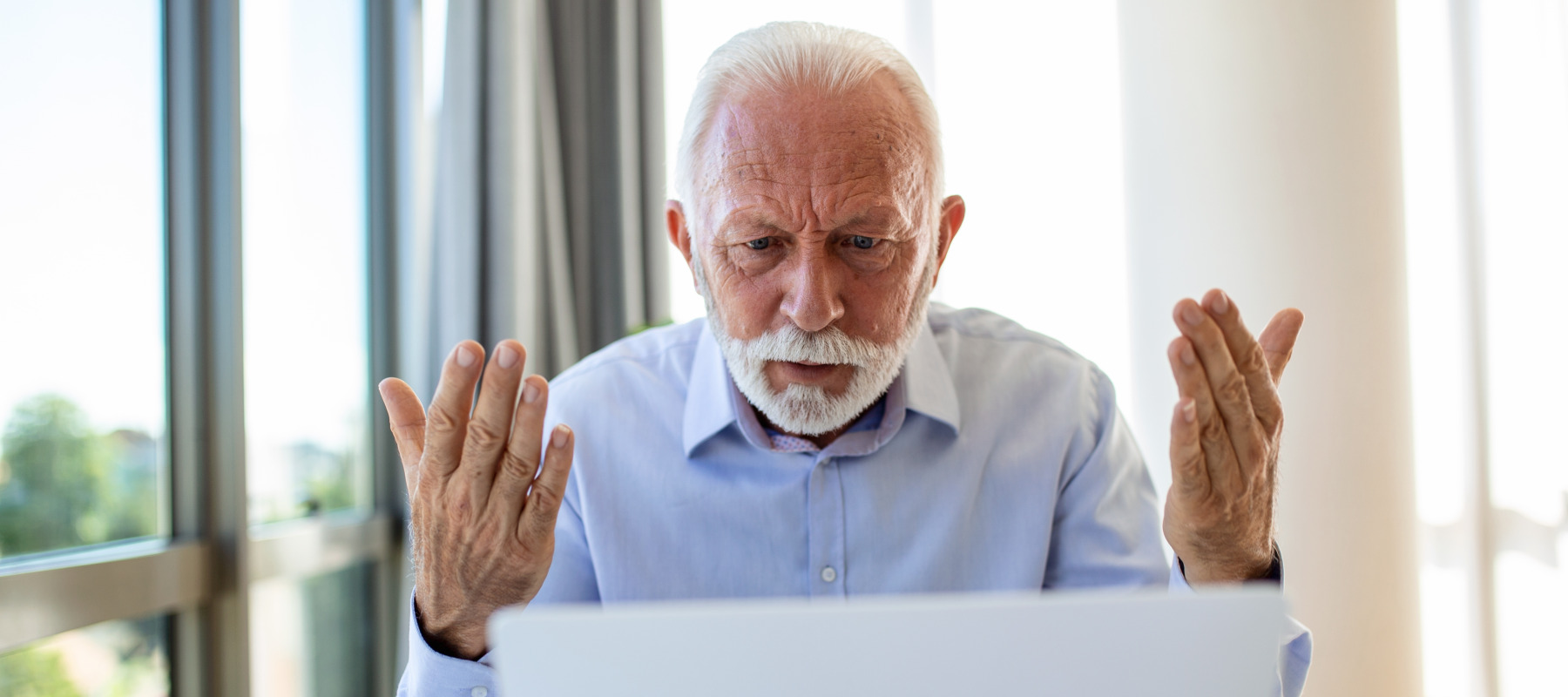 Frustrated seniors looking at a computer.