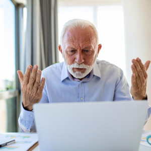 Frustrated seniors looking at a computer.
