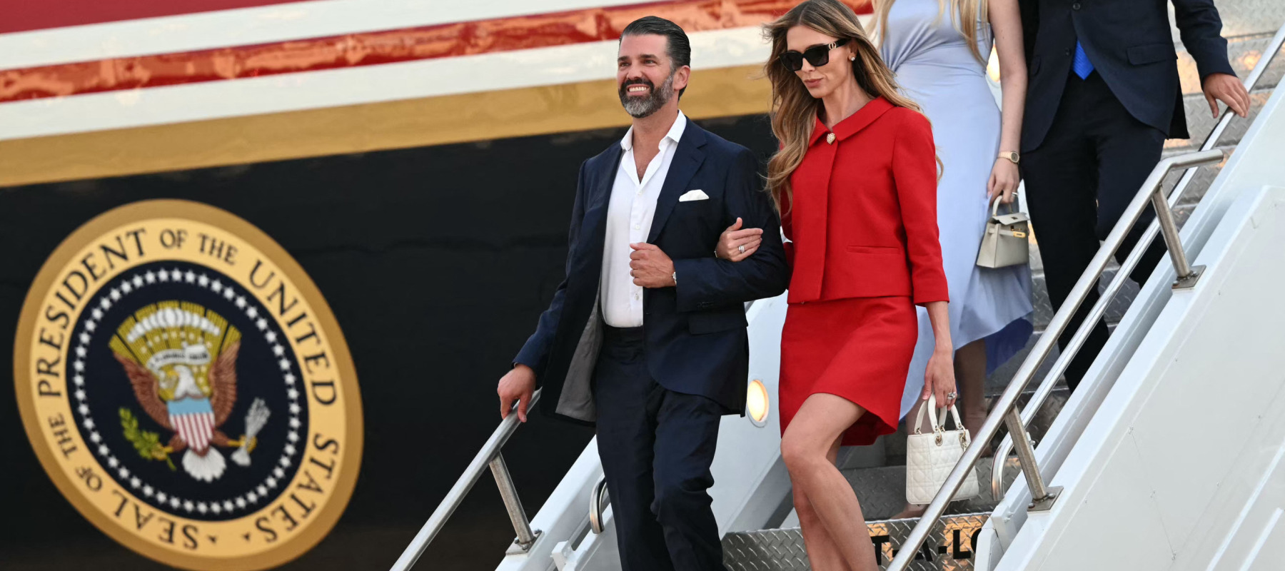 Donald Trump Jr. and his wife Bettina Anderson stepping off Air Force One.