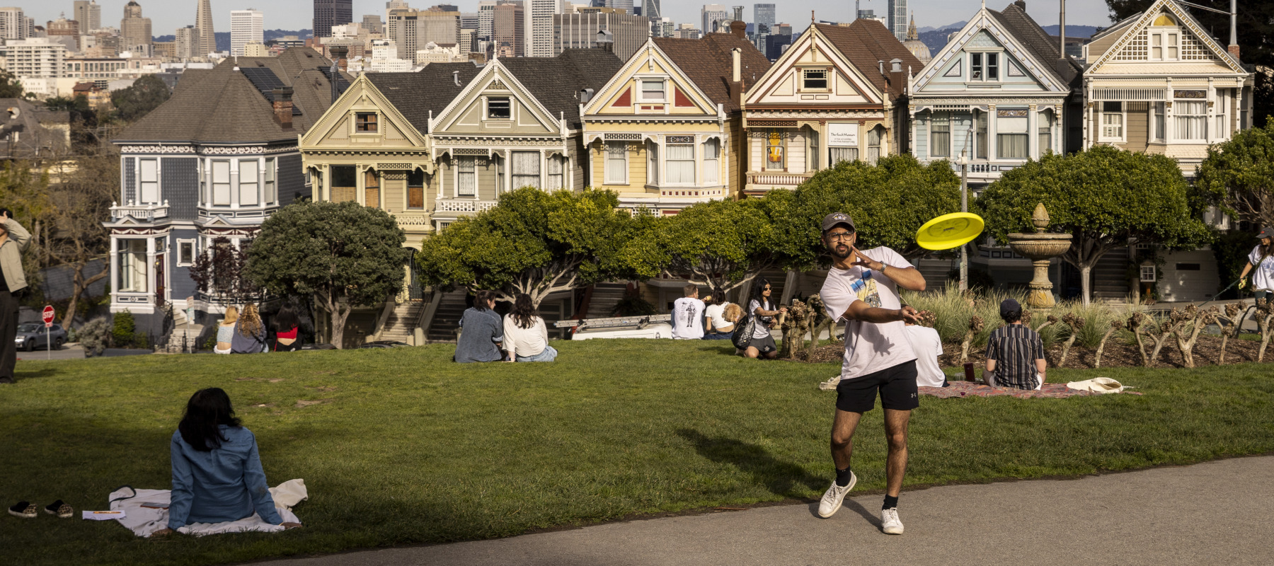 Visitors enjoying their time at Alamo Square Park in San Francisco.