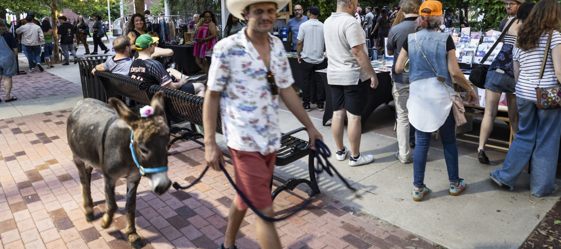 A visitor and his donkey watch the 20th annual Tulsa Tough bike race.