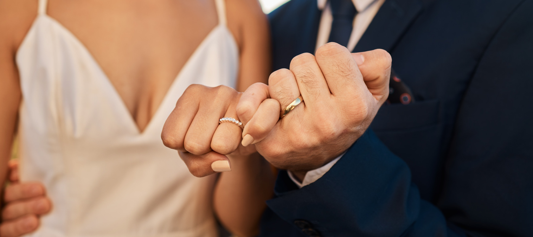 Newly married couple holding hands at wedding