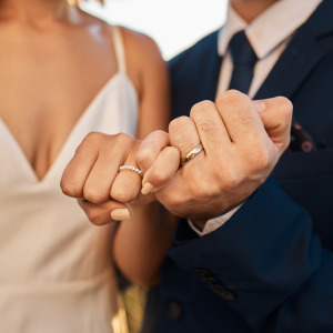 Newly married couple holding hands at wedding