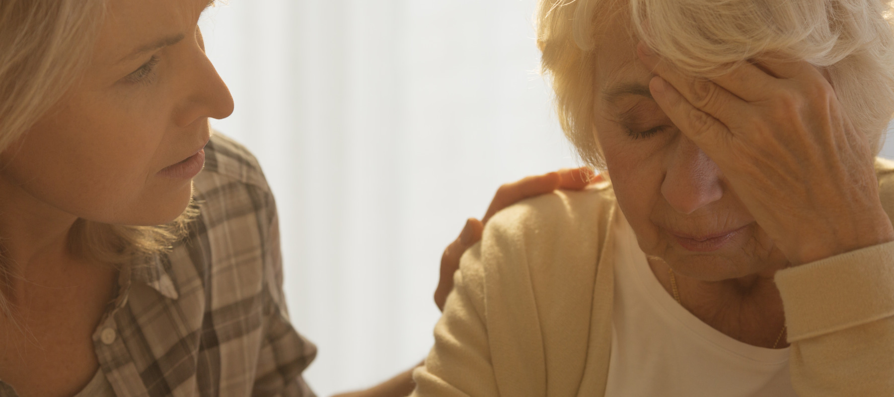 woman consoling senior woman