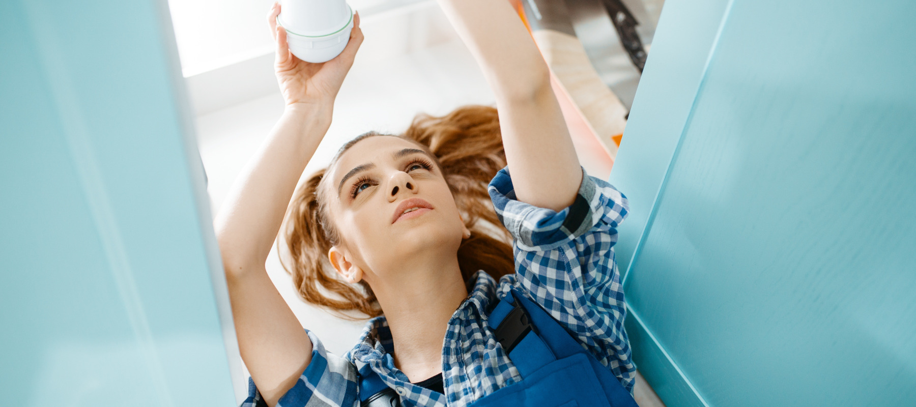 Female plumber working on a sink
