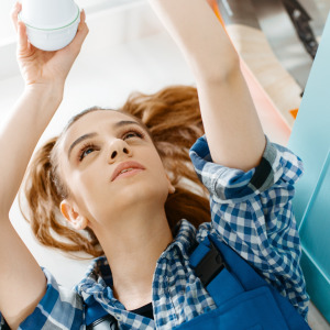 Female plumber working on a sink