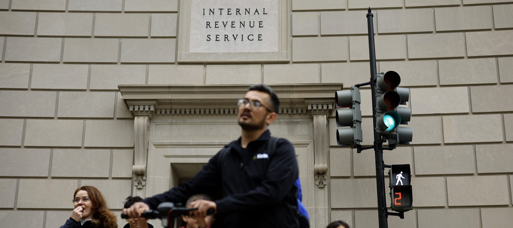 D.C. residents walk past the headquarters of the Internal Revenue Service near the National Mall.