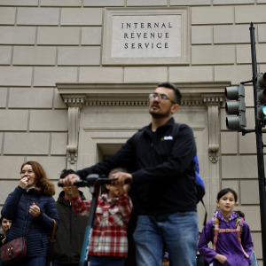 D.C. residents walk past the headquarters of the Internal Revenue Service near the National Mall.