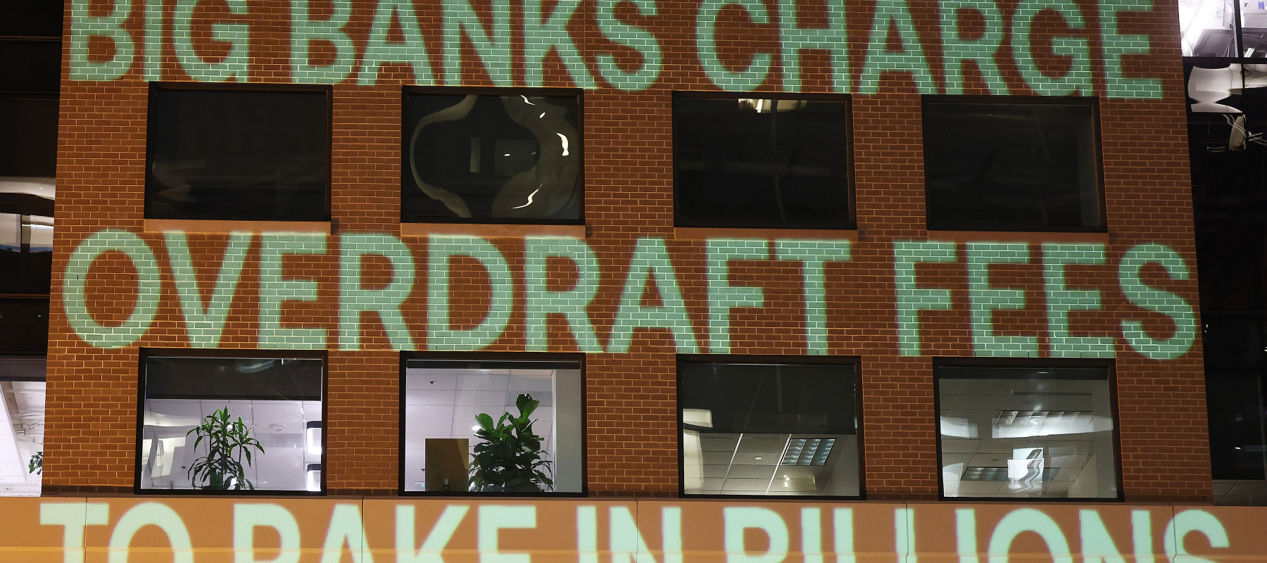 Government Watchdog Accountable.US projects a graphic onto the Consumer Bankers Association HQ to highlight alleged big bank profiteering via overdraft junk fees.