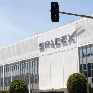 Exterior view of the SpaceX headquarters with recovered Falcon 9 rocket booster on display in Hawthorne, California.